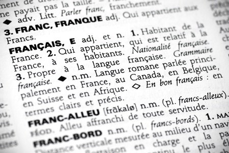 Macro shot with focus on the word franï¿½ais and its definition in a french dictionary.の写真素材