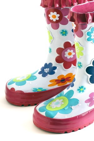 Fun little girl's colorful flower rain boots isolated on white.の写真素材