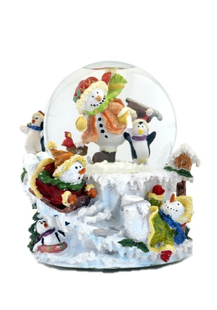 Musical snowglobe with snowmen and penguins enjoying winter.の写真素材
