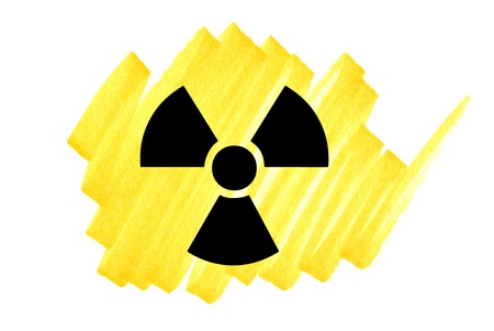 Radioactivity symbol in black on yellow ink marker scribble.の写真素材