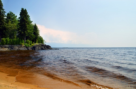 Beautiful sunny summer day on the beach of a northern lake in Canada.の写真素材