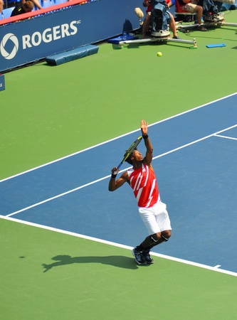 Gael Monfils serving the ball at the Rogers cup 2011 in Montreal, Quebec, Canada, the tennis player is about to spring in the air and hit hard.のeditorial素材