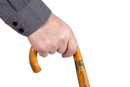 Senior man's hand hording an old wood cane to support himself as he walks, great details.の写真素材