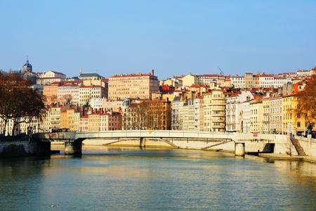 First morning light on the Saone river with typical bridge and old architecture, european style historical buildings and church.の写真素材