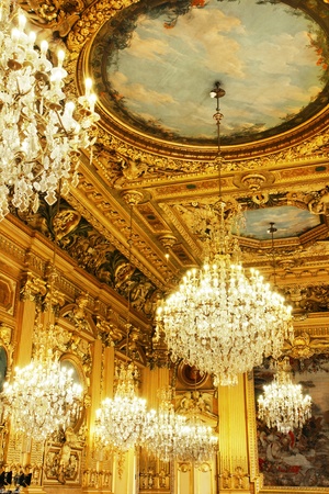 Opulent cristal chandeliers and gold leaves wood carved and painted ceiling, part of a french historical building, Lyon, France.のeditorial素材