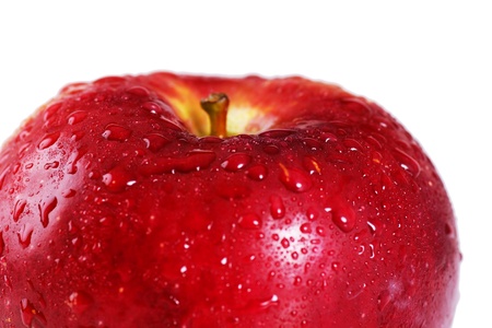 Beautiful studio shot of a fresh and wet red apple looking delicious, with water droplets driping off it over white, perfect nutrition or diet background.の写真素材