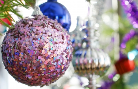 Candid shot of traditional natural fir Christmas tree ornaments with focus on pink bauble, perfect holiday background or for card.の写真素材