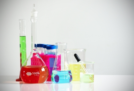 Science, research or chemistry concept: set of different laboratory glassware, flask, beaker and others filled with colorful chemicals or liquids.の写真素材