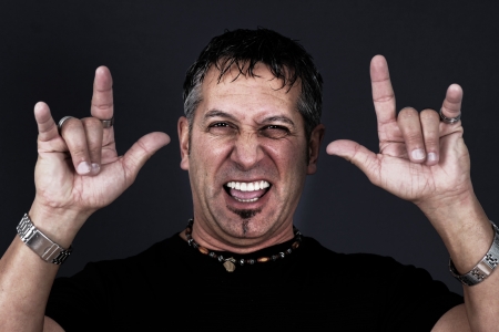 Metal or biker guy making the devil gestures with his handsの写真素材