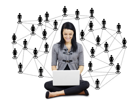 Network or social media concept: young brunette woman or student with laptop surrounded by men and women silhouettesの写真素材