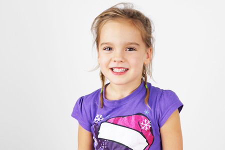 Portrait of sweet and cute happy little blond girl の写真素材