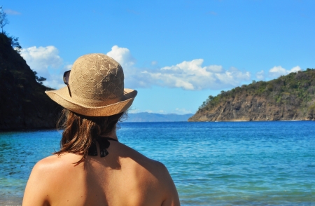 Young woman's back, looking at the sea at the beach in Costa Ricaの写真素材
