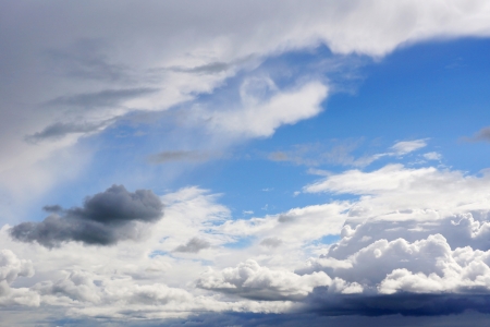 Beautiful and dramatic moody blue sky with white and grey cloudsの写真素材