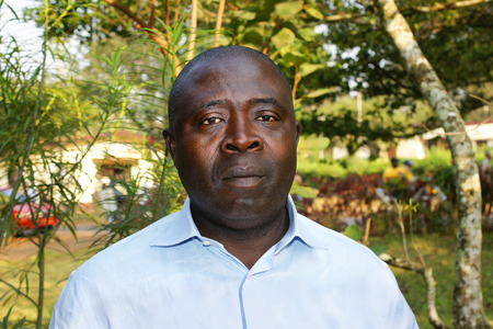 African black man portrait in blue shirt, real, no retouchingの写真素材