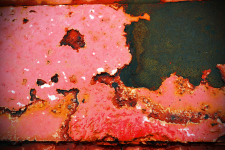 Macro of peeled red paint and rust on steel beam at a pierの写真素材