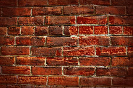 HDR very old grungy red brick wall background, vignettingの写真素材