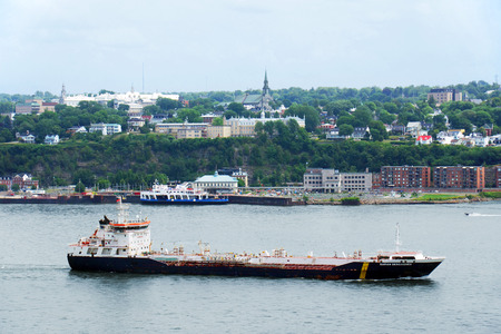 QUEBEC CITY, CANADA - JULY, 20: Large oil tanker on the St.Lawrence river in front of Quebec city. Twenty-five million tonnes of crude oil and various petroleum products are transported on the St.Lawrence seaway. Most vessels stop at the ports of Quebec aのeditorial素材