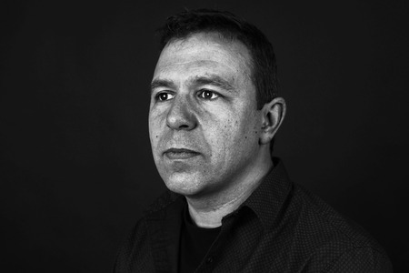 Dramatic portrait of a sullen man in black and whiteの写真素材