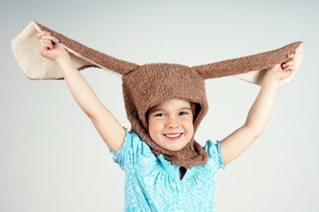 Little girl playing with rabbit costume showing big earsの写真素材