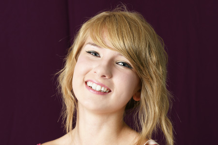 Portrait of a natural, young beautiful blond girl smilingの写真素材