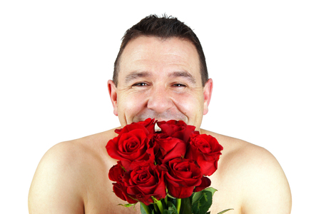Funny shirtless man with bouquet of red roses conceptの写真素材
