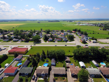 Aerial view of small Canadian town, agricultural fieldsの写真素材
