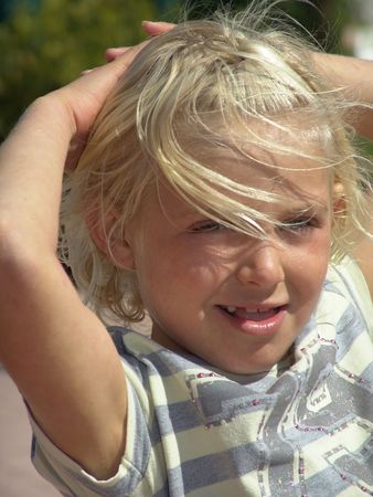 Young girl with blond hair outdoors の写真素材