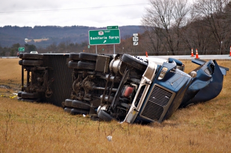 A tractor trailer on its side in the median after a roll over accident. の写真素材