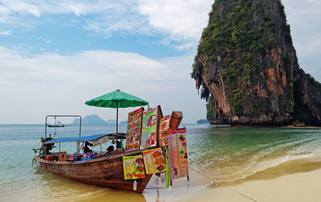KRABI, THAILAND - DEC 11, 2013: Boat restaurant on the Railay beach. Railay is a small peninsula located between Krabi and Ao Nang. Accessible only by boat due to the high limestone cliffs cutting off mainland access. のeditorial素材