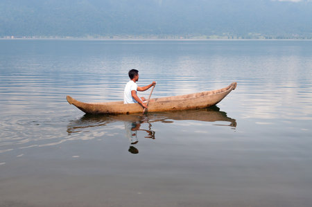 BUKITTINGGI, INDONESIA - DEC 25, 2013  Indonesian fisherman at Lake Maninjau  Danau Maninjau   Lake Maninjau is a caldera lake in West Sumatra   It has an area of 99,5 kmのeditorial素材