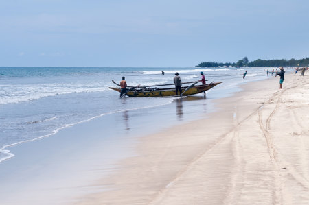 PADANG, INDONESIA - DEC 25, 2013  Fishermen on Tiku beach  Fishing is the main work in some villages  Fishermen pulling a fishing net about two hoursのeditorial素材