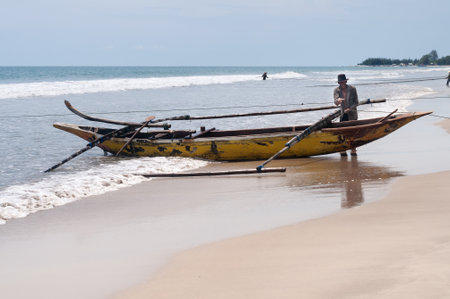 PADANG, INDONESIA - DEC 25, 2013  Fishermen on Tiku beach  Fishing is the main work in some villages  Fishermen pulling a fishing net about two hoursのeditorial素材
