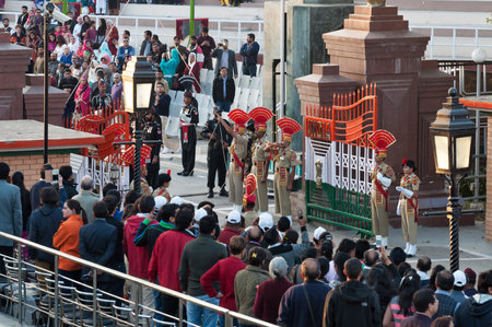 AMRITSAR, INDIA, DEC - 6, 2014: The India-Pakistan Wagah Border Closing Ceremony. It happens at the border gate, two hours before sunset each day. The flag ceremony is conducted by Indian Border Security Force and Pakistan Rangers.のeditorial素材