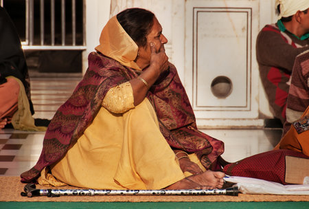 AMRITSAR, INDIA, DEC - 7, 2014: Unidentified woman in beige saree  in Golden Temple (Harmandir Sahib...