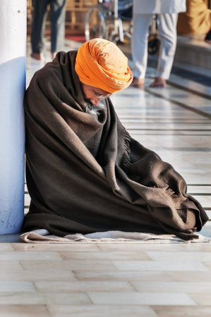 AMRITSAR, INDIA, DEC - 7, 2014: Unidentified Sikh man praying in Golden Temple (Harmandir Sahib also Darbar Sahib). Golden Temple is the holiest Sikh gurdwara located in the city of Amritsar, Punjab, India.のeditorial素材