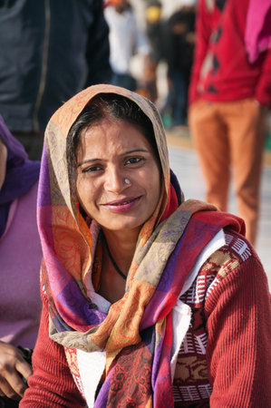 AMRITSAR, INDIA, DEC - 7, 2014: Unidentified woman  in Golden Temple (Harmandir Sahib also Darbar Sahib). Golden Temple is the holiest Sikh gurdwara located in the city of Amritsar, Punjab, India.のeditorial素材