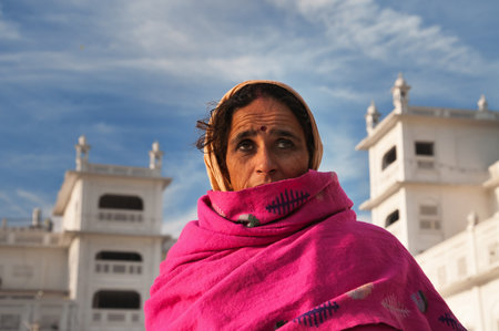 AMRITSAR, INDIA, DEC - 7, 2014: Unidentified woman  in Golden Temple (Harmandir Sahib also Darbar Sahib). Golden Temple is the holiest Sikh gurdwara located in the city of Amritsar, Punjab, India.のeditorial素材