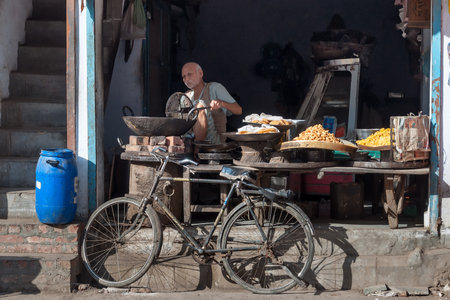 AMRITSAR, INDIA, DEC - 7, 2014: Unidentified Indian market vendor cooking and selling snack in ...