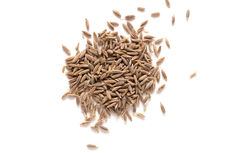Pile of Cumin seeds isolated on white background