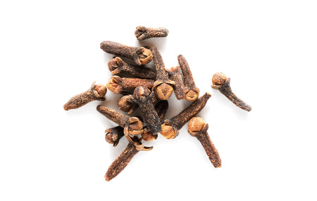 Pile of dry cloves isolated on white background