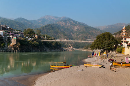 RISHIKESH, INDIA - DEC 8, 2014: Laxman Jhula bridge over Ganges river.  Rishikesh is  World Capital of Yoga,  has numerous yoga centres that also attract touristsのeditorial素材