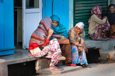 VRINDAVAN, INDIA - DEC 15, 2014:  Unidentified Indian women sit and chat on a house porch. Vrindavan is considered to be a holy place. The major tradition followed in the area is Vaisnavism. It is the place where Krishna spent his childhood days.のeditorial素材