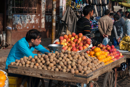 AGRA, INDIA - DEC 16, 2014: An unidentified Indian vendor with fruit in market. Agra is major tourist destination because of its many splendid Mughal-era buildings, most notably the Taj Mahal, Agra Fort and Fatehpur Sikriのeditorial素材