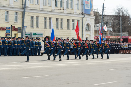 NIZHNY NOVGOROD, RUSSIA - MAY 4, 2015: Soldiers in uniform with flags are at rehearsal of Military Parade commemorating the 70th anniversary Victory on Pozharsky and Minin Squareのeditorial素材