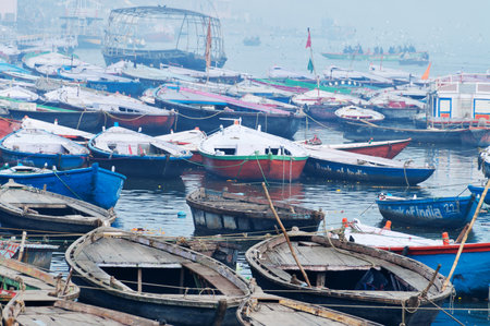 VARANASI, INDIA - DEC 23, 2014: Boats on sacred river Ganges foggy morning. Varanasi. Uttar Pradesh, Indiaのeditorial素材