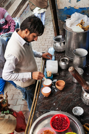 VARANASI, INDIA - DEC 23, 2014: Unidentified Indian milkman prepares the popular drink lassi in Blue lassi shop in the old city of Varanasi. Uttar Pradesh, Indiaのeditorial素材