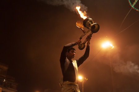VARANASI, INDIA - DEC 23, 2014: Unidentified Indian priest performs religious Ganga Aarti ceremony or fire puja at Dashashwamedh Ghat in Varanasi. Uttar Pradeshのeditorial素材