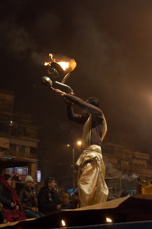 VARANASI, INDIA - DEC 23, 2014: Unidentified Indian priest performs religious Ganga Aarti ceremony or fire puja at Dashashwamedh Ghat in Varanasi. Uttar Pradeshのeditorial素材