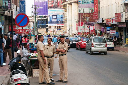 BANGALORE, INDIA - DEC 25, 2014: Policemen on Commercial street. Commercial street in Bangalore is one of the main shopping complexes in Indiaのeditorial素材