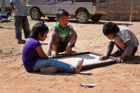 BANGALORE, INDIA - DEC 26, 2014: Unidentified Indian children playing on the street in Bangalore.  Karnataka. Indiaのeditorial素材